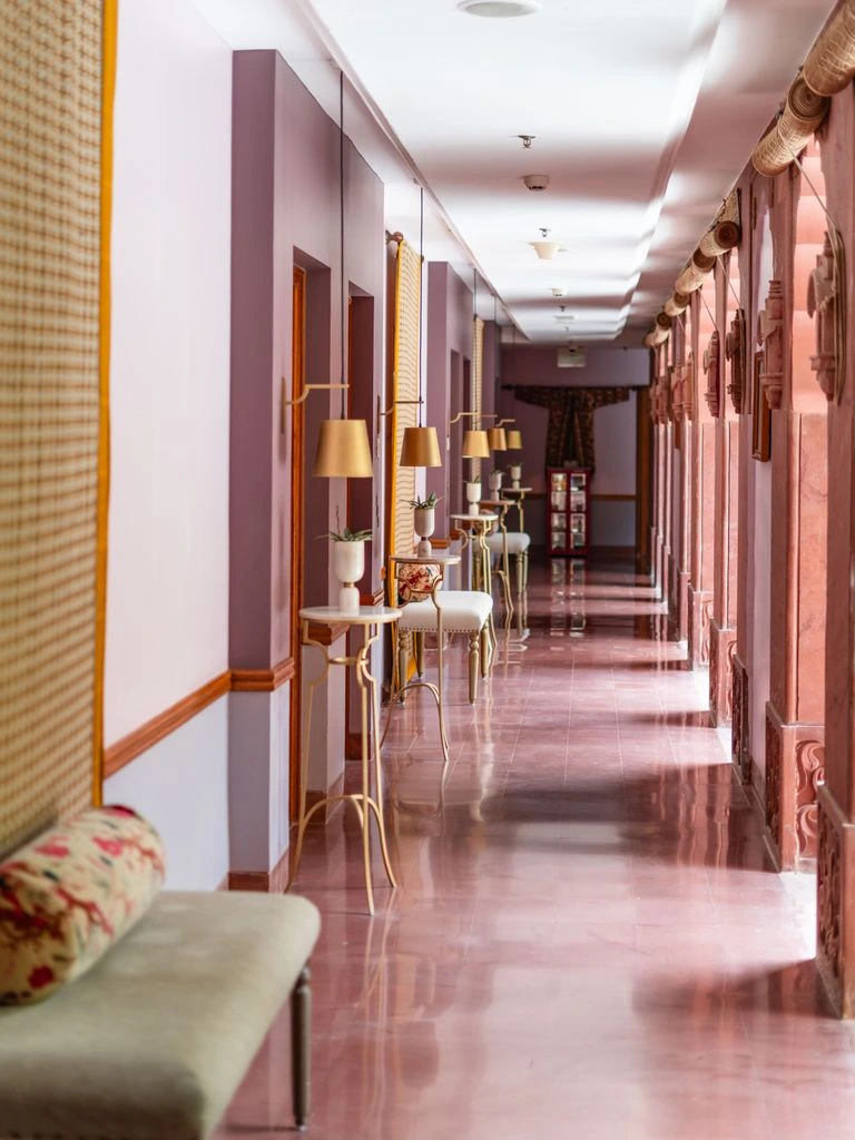 A Junior Suite with arched windows and a separate velvet sitting area.